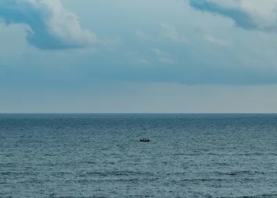 A lone fishing boat on the open Bay of Bengal