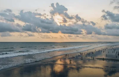Waves breaking on Cox's Bazar beach under an evening sky