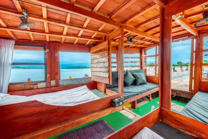 A wood-panelled houseboat cabin looking out over the water